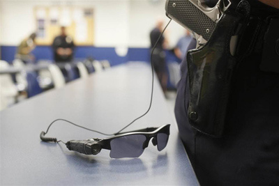 An on-body police video camera is clipped to a Los Angeles Police officers' glasses during a demonstration for media in Los Angeles Wednesday, Jan. 15, 2014. Police officers assigned to foot patrols of downtown Los Angeles began wearing the cameras on Wednesday as the city evaluates different models to include in its policing. (AP Photo/Damian Dovarganes)