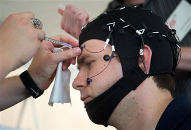 Russ Martin of American Automobile Association (AAA), is hooked to an electroencephalographic (EEG)-configured skull cap, during a demonstration in support of their new study on distracted driving in Landover, Md., Tuesday, June 11, 2013. (AP Photo/Manuel Balce Ceneta)