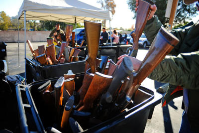 Guns are collected in bins during the city-sponsored gun buyback event in Van Nuys on Dec. 26, 2012. (Andy Holzman/Los Angeles Daily News)