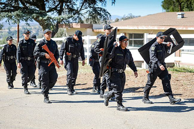 Explorers from Bell move in to take part in a felony arrest drill at Pitchess Detention Center on Sunday, March 24, 2013. Law enforcement explorer posts participated in a weekend-long competition to sharpen their skills. (David Crane/Staff Photographer)