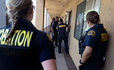 San Bernardino County Probation officers check on a probationer at a motel during a probation and Prison Realignment compliance sweep Thursday, May 23, 2013, in Ontario. (Jennifer Cappuccio Maher/Staff Photographer)