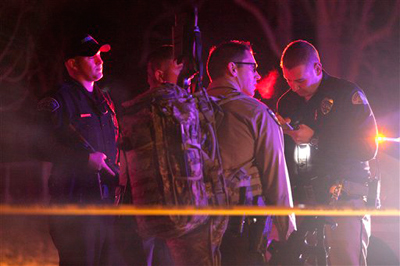 Police officers and emergency crew are seen near 3268 Jackson Street in Ogden, Utah where 6 police officers were shot, including those from the Weber-Morgan Narcotics Strike Force and the Ogden Police Department, while serving a warrant Wednesday Jan. 4, 2012. The suspect was also shot. (AP Photo/Erin Hooley - Standard-Examiner)