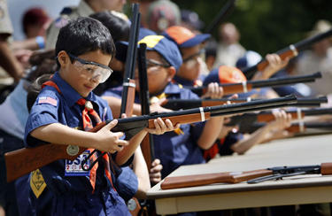 Ivan Ruiz, 7, a South Gate Tiger Cub Scout, cocks his BB gun for the first time as nearly 4,000 Los Angeles County Boy, Cub and Adventure Scouts and their adult leaders celebrate a three-day Cen-Ten-O-Ree camping celebration marking the 100th anniversary of the founding of the Boy Scouts of America at the Whittier Narrows Recreation Area in El Monte on May 22, 2010. Credit: Allen J. Schaben / Los Angeles Times
