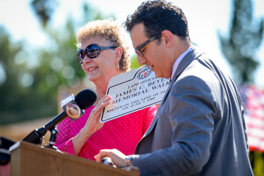 Cathy Beyea is presented with a replica sign by Los Angeles city council member Bob Blumenfield at a ceremony which named a memorial walk after Beyea's son James Beyea who was slain while on duty as an LAPD officer in 1988. An effort had been underway for some time to get the walkway named in honor of the officer. ( Photo by David Crane/Los Angeles Daily News )
