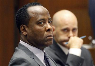 FILE - In this Oct. 3, 2011 file photo, Dr. Conrad Murray listens to testimony seated near his attorney Nareg Gourjian, right, during Murray's trial in the death of pop star Michael Jackson in Los Angeles. Gov. Jerry Brown and others who supported the dramatic shift in California's sentencing law that took effect this week have said it will send only those convicted of nonviolent or non serious crimes to county jails instead of state prison, a change designed to save the state money and reduce inmate crowding. Among those who could be affected by the new law if convicted is Murray. Legal experts said he would serve his maximum four year sentence in a Los Angeles County jail instead of state prison. ((AP Photo/Mario Anzuoni, Pool, File))