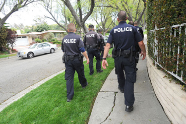 Members of LAPD's Parole Compliance Unit make their way up to a Woodland Hills home before conducting a compliance check on a parolee April 12, 2012. (Andy Holzman/Daily News Staff Photographer)