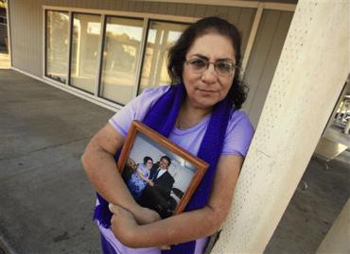 Rich Pedroncelli / APIn this photo taken Nov. 4, 2011, Karen Carrisosa is seen with a photo of her and her husband Larry, at the site where he was killed in Sacramento, Calif. Carrisosa became concerned when officials found a Facebook posting from Corcoran State Prison inmate Fredrick Garner who is serving a 22-year, involuntary manslaughter sentence for killing Larry 11 years ago. Carrisosa is a victim of a disturbing trend: Inmates who use smuggled mobile devices or work through third parties to access social networking sites giving them the ability to harass their victims and victim's families.