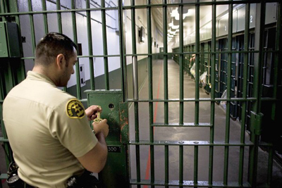 A Los Angeles County sheriff's deputy prepares to unlock a security door at Men's Central Jail in downtown L.A. (Jay L. Clendenin, Los Angeles Times / November 3, 2011)