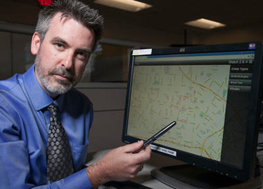 In this photo taken Friday, June 29, 2012, Jeff Brantingham, anthropology professor at the University of California Los Angeles, displays a computer generated "predictive policing," zones at the Los Angeles Police Department Unified Command Post (UCP) in Los Angeles. Police officials say they are having success with a computer algorithm model that helps determine where to send officers to prevent or possibily interrupt a crime, which may serve as a model for other cash-strapped law enforcement agencies. (AP Photo/Damian Dovarganes) ( Damian Dovarganes )
