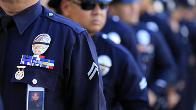 Mark Boster / Los Angeles TimesLAPD officers wear a badge honoring fallen Officer Roberto Sanchez.