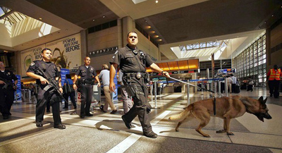 Under tightened security after Osama bin Laden's death, Airport Police Officer Robert Corchado and his dog Malo lead a patrol of Tom Bradley International Terminal at LAX. (Al Seib/Los Angeles Times / May 2, 2011)