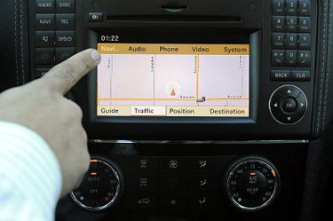 Navigation systems are among driver distractions worrying federal safety regulators. Carmakers are being urged to disable functions such as text messaging and Internet browsing unless the car is parked. (Michael Owen Baker/Staff Photographer)