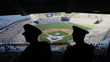 The LAPD is out in force at Dodger Stadium as a zero-tolerance policy gets underway. (Gary Friedman, Los Angeles Times)