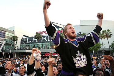 Credit: Mike Quigley, 22, of Garden Grove celebrates with a crowd of Kings fans after the team won Game 3 of the Stanley Cup finals Monday. Credit: Christina House/For The Times