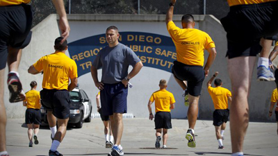Geoff DeCesari, recruit training officer at the San Diego Regional Public Safety Training Institute in Mira Mesa at Miramar College, watches San Diego police and sheriff's recruits during morning physical training. - Howard Lipin