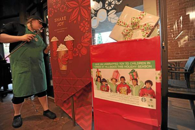 A gift donation box stand inside the front door at Starbucks on Honolulu Avenue in Montrose. Residents throughout the San Gabriel Valley and Los Angeles County can help brighten a child's holiday season by donating new, unwrapped gifts and toys at select local Starbucks stores. John McCoy/Staff Photographer