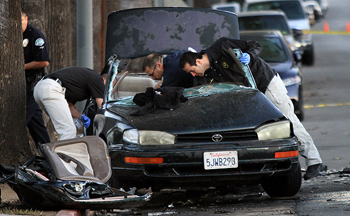 Photo: LAPD officers investigate one of two vehicles involved in a fatal accident at 4th Street and Boyle Avenue in Boyle Heights on Friday morning. Credit: Irfan Khan / Los Angeles Times