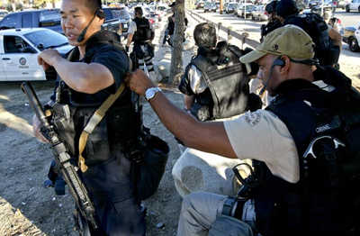 SWAT team members near Foothill Boulevard and the 210 Freeway. Credit: Anne Cusack/ Los Angeles Times