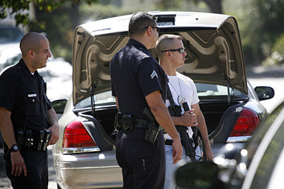 LAPD officers on Arrowhead Drive in the Hollywood Hills, where they are investigating a hoax connected to a reported home invasion robbery call Wednesday at a Hollywood Hills residence owned by actor Ashton Kutcher. (Bob Chamberlin / Los Angeles Times / January 24, 2013)