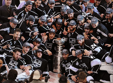 L.A. Kings' players pose with the Stanley Cup after they beat the New Jersey Devils 6-1 in Game 6 of the NHL Stanley Cup Final at the Staples Center on June 11, 2012. (Andy Holzman/Staff Photographer)