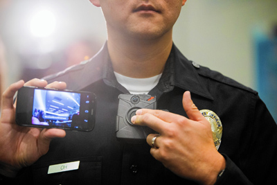 LAPD Officer Jin Oh displays video from a body camera. Some residents have raised privacy and civil liberties questions about the use of the devices. (Marcus Yam / Los Angeles Times)