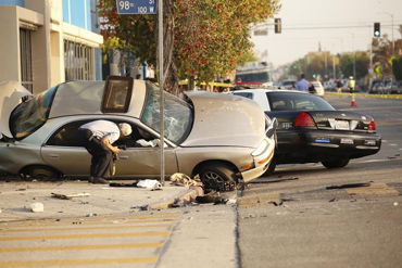 A team of investigators surveys the scene of the crash that killed Julio Reyes-Salvador. (Al Seib / Los Angeles Times)