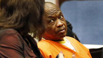 Lonnie Franklin Jr., right, the alleged Grim Sleeper serial killer, accused of murdering 10 women in South Los Angeles, listens to one of his attorneys' Louisa Pensanti, left, during a pre-trial hearing on Monday August 17, 2015.  (Al Seib / Los Angeles Times)