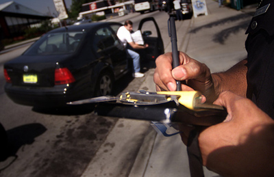 An LAPD officer writes a ticket for a driver who didn't stop for pedestrians on Reseda Boulevard in Northridge in 2002.