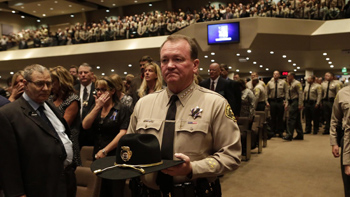 Los Angeles County Sheriff Jim McDonnell enters Lancaster Baptist Church carrying Sgt. Steve Owen's hat at the memorial for the slain deputy. Irfan Khan / Los Angeles Times