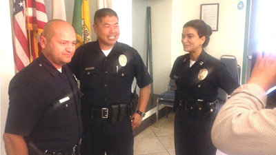 Los Angeles Police Department Officers Andrew Cardenas (left) and Johnny Han (middle) congratulated by Capt. Lillian Carranza on Tuesday, March 25, 2014 for saving the life of a child. @PatrickNBCLA via Twitter