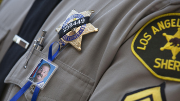 A black band with Sgt. Steve Owen's badge number is worn by Los Angeles County Sheriff Deputies. Brian van der Brug / Los Angeles Times
