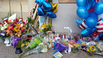 Flower, balloons, candles and cards were left the the sheriff's Lancaster Station on Oct. 6, 2016, to honor Sgt. Steve Owen, who was killed the previous day. (Credit: KTLA)