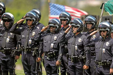 LAPD officers salute Tuesday, April 22, 2014, at the burial of LAPD officer Chris Cortijo, at Forest Lawn Hollywood Hills. (Photo by Michael Owen Baker/Los Angeles Daily News) 